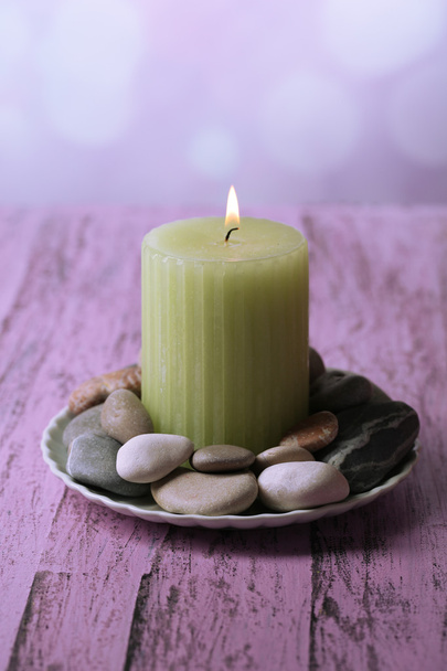 Composition with spa stones, candle  on color wooden table, on light background - Zdjęcie, obraz