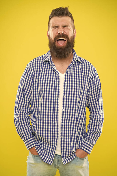 Emotional man with beard on yellow backdrop. Brutal bearded hipster in checkered shirt. Summer hipster. Male fashion spring style. Mature happy man. positive emotions. feeling and emotions concept - Фото, зображення
