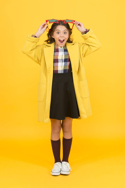 Perfect for school party. Happy party girl yellow background. Little kid wear party glasses with color lenses. Cute small child smile with party look. School holidays. Partying and celebrating - 写真・画像