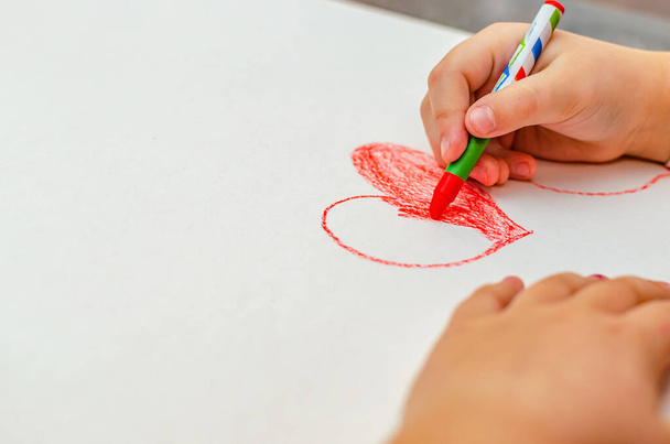 valentines day, girl draws heart on paper, copy space - Zdjęcie, obraz