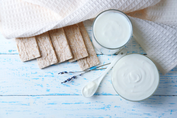 Homemade yogurt and tasty Tasty crispbread on wooden table background - 写真・画像