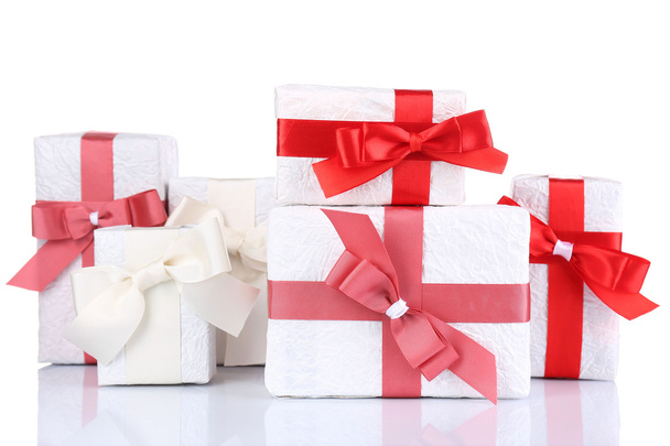 Beautiful gifts with red ribbons, isolated on white - Foto, Bild