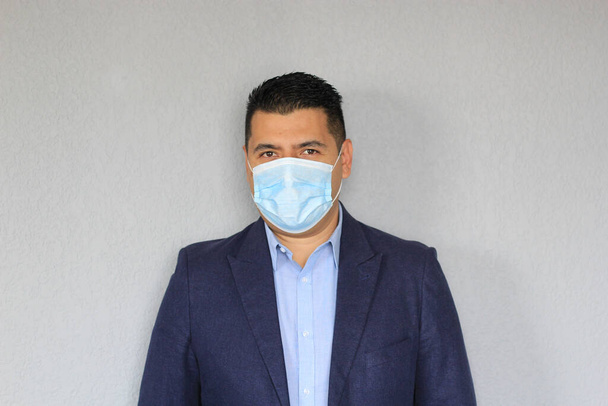 Επίσημος ενήλικος Λατίνος άνδρας με προστατευτική μάσκα, νέος φυσιολογικός covid-19 - Φωτογραφία, εικόνα