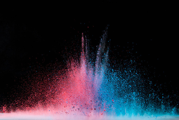 Explosion of colored powder isolated on black background. Abstract colored background - Foto, Imagem