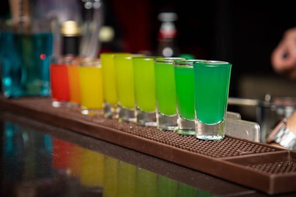 COLORFUL TEQUILA SHOTS SERVED IN A BAR - Foto, Imagen
