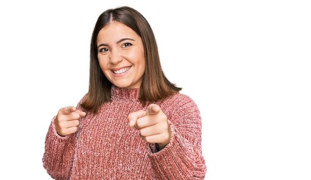 Young beautiful woman wearing casual clothes pointing fingers to camera with happy and funny face. good energy and vibes.  - Foto, imagen