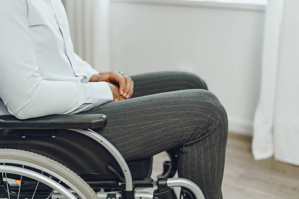 Unrecognizable man sitting in wheelchair close up - Фото, изображение