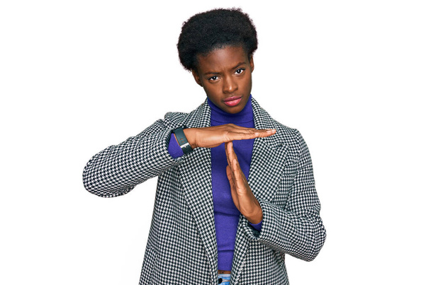 Young african american girl wearing casual clothes doing time out gesture with hands, frustrated and serious face  - Φωτογραφία, εικόνα