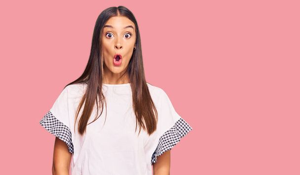 Young hispanic woman wearing casual clothes afraid and shocked with surprise expression, fear and excited face.  - Photo, Image