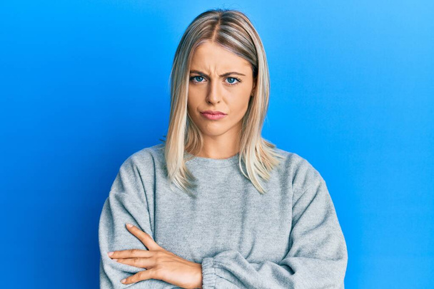 Beautiful blonde woman wearing casual clothes skeptic and nervous, disapproving expression on face with crossed arms. negative person.  - Photo, Image