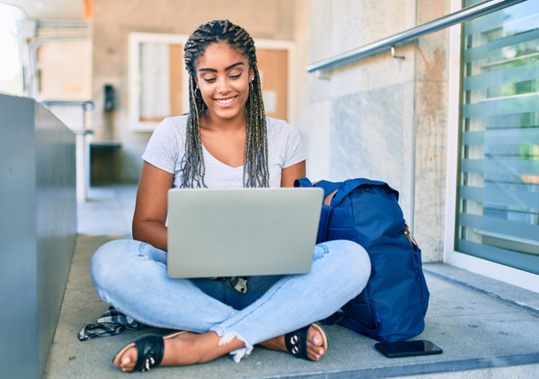 Young african american student woman smiling happy using computer laptop at the university campus - Foto, Imagem