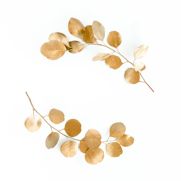 Gold round frame made of gold branches eucalyptus and leaves isolated on white background. lay flat, top view - 写真・画像