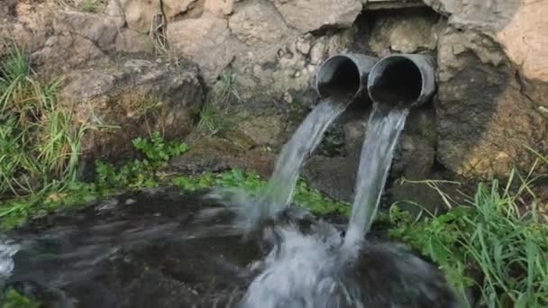 A clean, transparent mountain water stream that flows down metal gutter close up view - Footage, Video