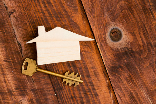 Wooden toy house and house keys close up - Φωτογραφία, εικόνα