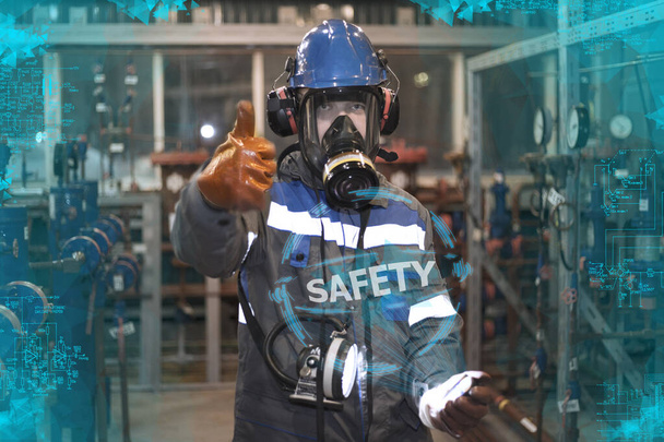 Industrial Safety. Means of protection against harmful substances, control of the gas pollution of oil and gas equipment, the operator in a gas mask measures hazardous substances, tinting dark blue - Photo, Image