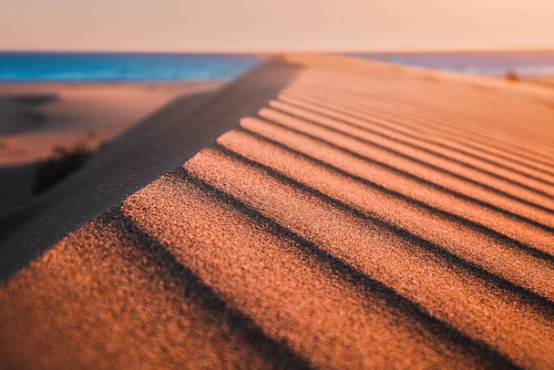 Patara beach is a famous tourist landmark and natural destination in Turkey. Majestic view of orange sand dunes and hills glows in the rays of the warm sunset. - Foto, imagen