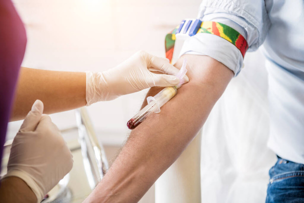 Nurse taking a patients blood sample at lab - Valokuva, kuva