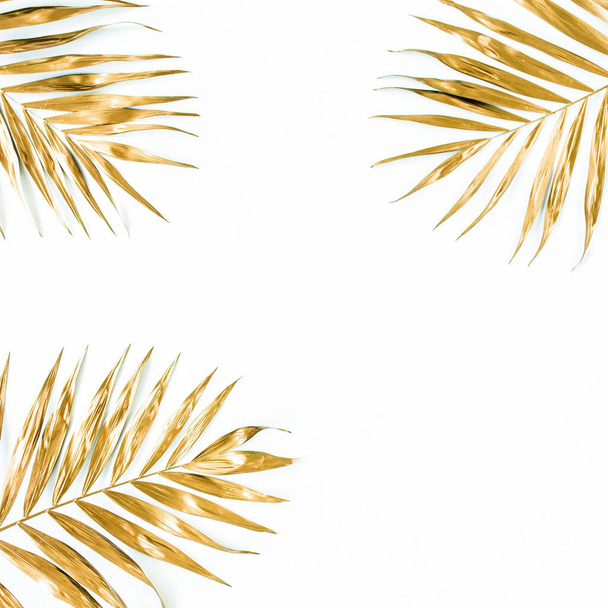 Gold tropical palm leaves on white background. Flat lay, top view minimal concept. - Fotó, kép