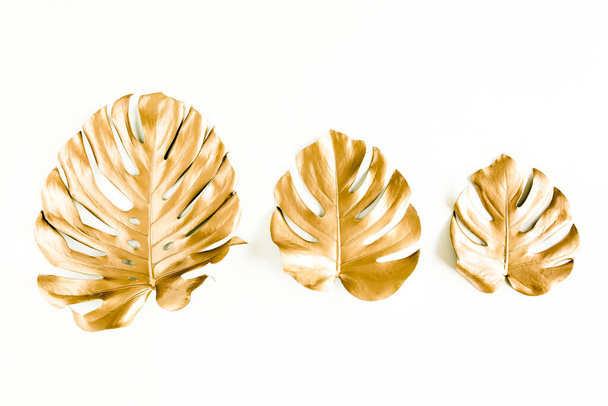 Gold tropical palm leaves Monstera on white background. Flat lay, top view minimal concept. - Foto, Imagem