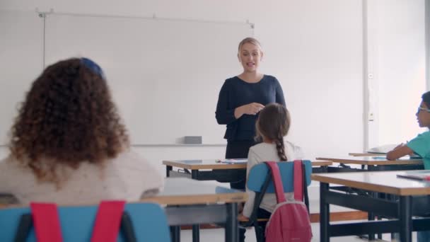 Freundliche Lehrerin spricht am Whiteboard - Filmmaterial, Video