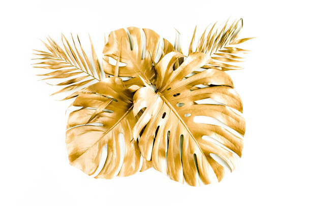 Gold tropical palm leaves Monstera on white background. Flat lay, top view minimal concept. - 写真・画像