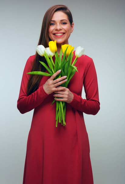 Happy woman in red dress holding tulips flowers. girl with toothy smile isolated portrait. - Fotografie, Obrázek