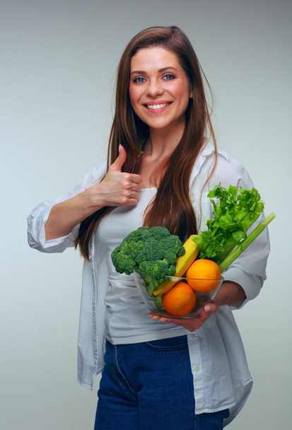 Happy woman with long hair holding healthy food set for vegan dishes and showing thumb up. isolated female portrait. - Fotoğraf, Görsel