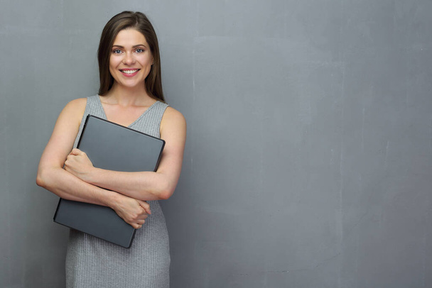 Smiling business woman holding laptop. - Fotó, kép