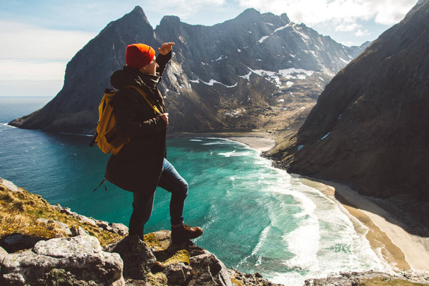 Traveler man stand on cliff edge alone enjoying aerial view backpacking lifestyle travel adventure outdoor vacations. Place for text or advertising. - 写真・画像