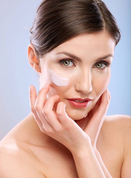 Beauty portrait of woman with white cream on face. Skin care concept. - Fotó, kép