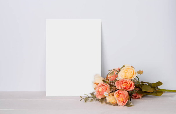 Valentine day, greeting card mockup empty and flower on wooden table, postcard blank with romance on desk, present in anniversary and celebration, paper for message with vertical, holiday concept. - Zdjęcie, obraz