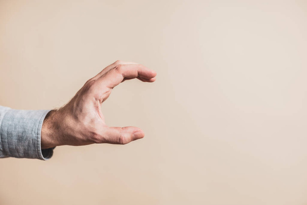 Close up image of male hand in holding gesture. - Φωτογραφία, εικόνα