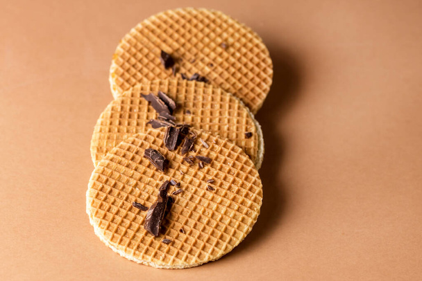 Three Tasty Holland Waffles with Caramel Decorated With Chocolate on Light Brown Background Horizontal - Foto, afbeelding