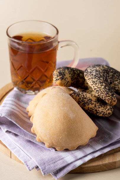 Homemade Sweet Delicious Bun and Bun with Poppy Seeds on Napkin Yellow Background Vertical - Foto, Imagen