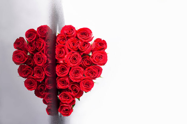 Květinové srdce. Symbolická láska a Valentýn. Rudé růže shromážděné ve tvaru srdce. Ukázková pohlednice. Květinové slavnostní pozadí. Kytice ve tvaru srdce. Reflexní efekt.Tvůrčí dekor.. - Fotografie, Obrázek