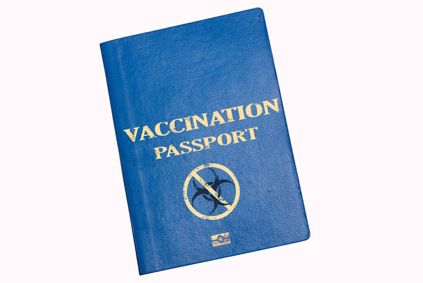 Passeport biométrique bleu sur fond blanc avec l'inscription PASSEPORT DE VACCINATION et panneau d'avertissement de danger biologique. Concept d'introduction d'un passeport ou d'une immunité de vaccination - Photo, image