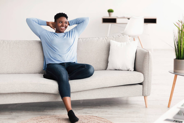 Black woman having rest at home on the couch - Foto, Imagem