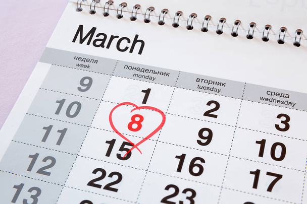 Calendar with a red date of March 8. The days of the week are written in English and Russian. - Φωτογραφία, εικόνα