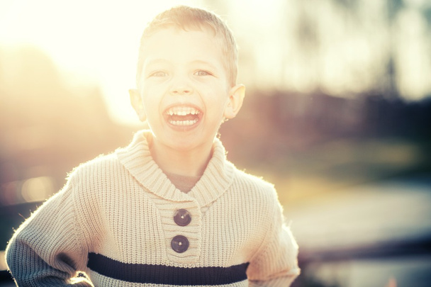 Smiling child portrait of little boy playing - Fotó, kép