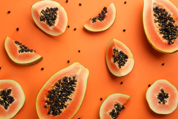 Fresh ripe papaya fruits on orange background, flat lay - Photo, image