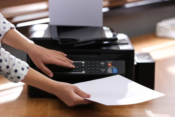 Employee using modern printer in office, closeup - Foto, immagini