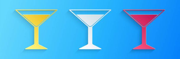 Paper cut Martini glass icon isolated on blue background. Cocktail icon. Wine glass icon. Paper art style. Vector. - Vector, Image