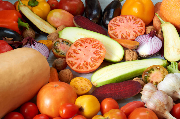 Various fresh organic vegetables: carrots, garlic, eggplants, zucchini, beet, tomatoes on the gray background. Raw ingredients for veggie healthy or diet dish - Φωτογραφία, εικόνα