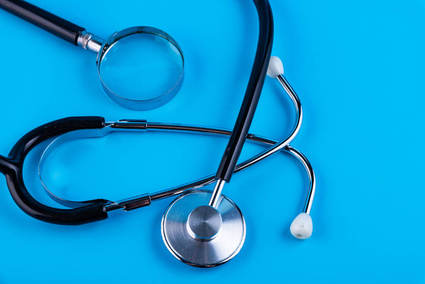 Stethoscope or phonendoscope, magnifying glass on the blue background. Medical Concept. Closeup - Valokuva, kuva