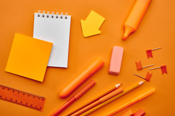 Office stationery supplies,macro view, orange background. School or education accessories - Photo, Image