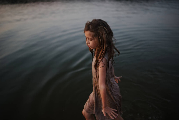 little cute girl with long hair on the lake - Foto, Imagen