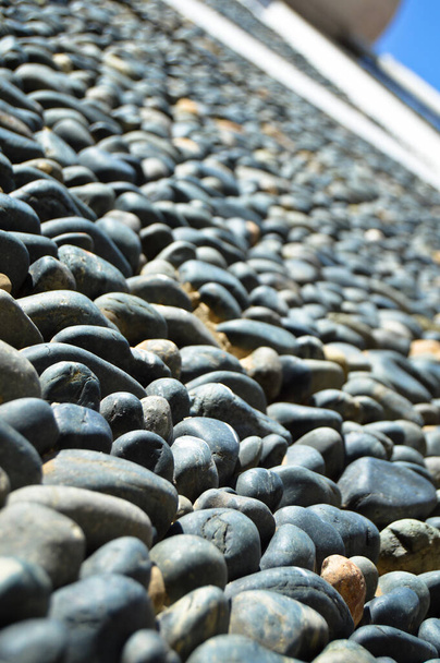 Wall texture decorated with blue pebbles, pebbles glued to the wall, background pebble wall texture - Photo, Image