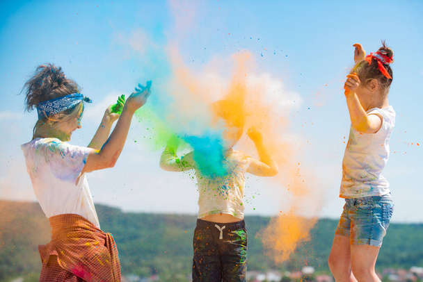 Funny kids in summer. Colored splash powder and color dust. - Zdjęcie, obraz