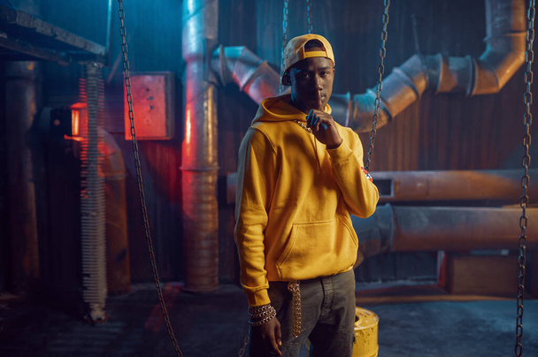 Stylish rapper in yellow hoodie and baseball cap - Photo, Image