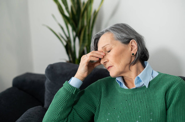 Senior lady experiencing a migraine or insomnia - Photo, image
